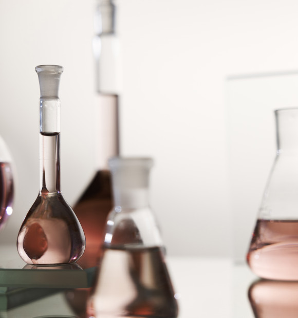 laboratory-glassware-with-pink-liquid-arrangement
			                